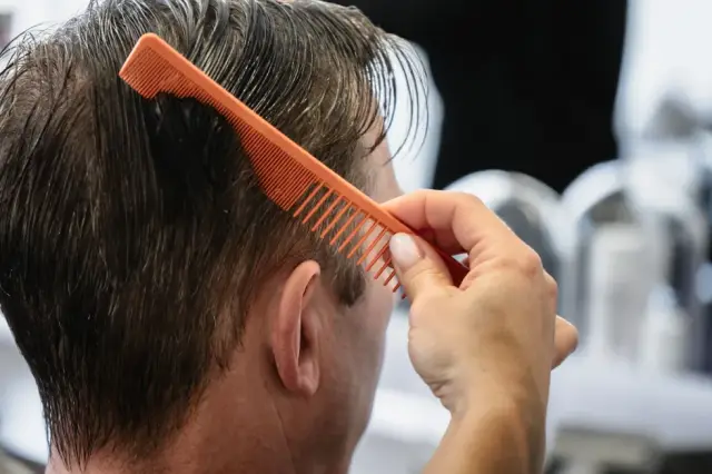 Kurzes graues Haar wird mit einem Kamm angehoben bei Kaiserreich Hairstyle in Nürnberg